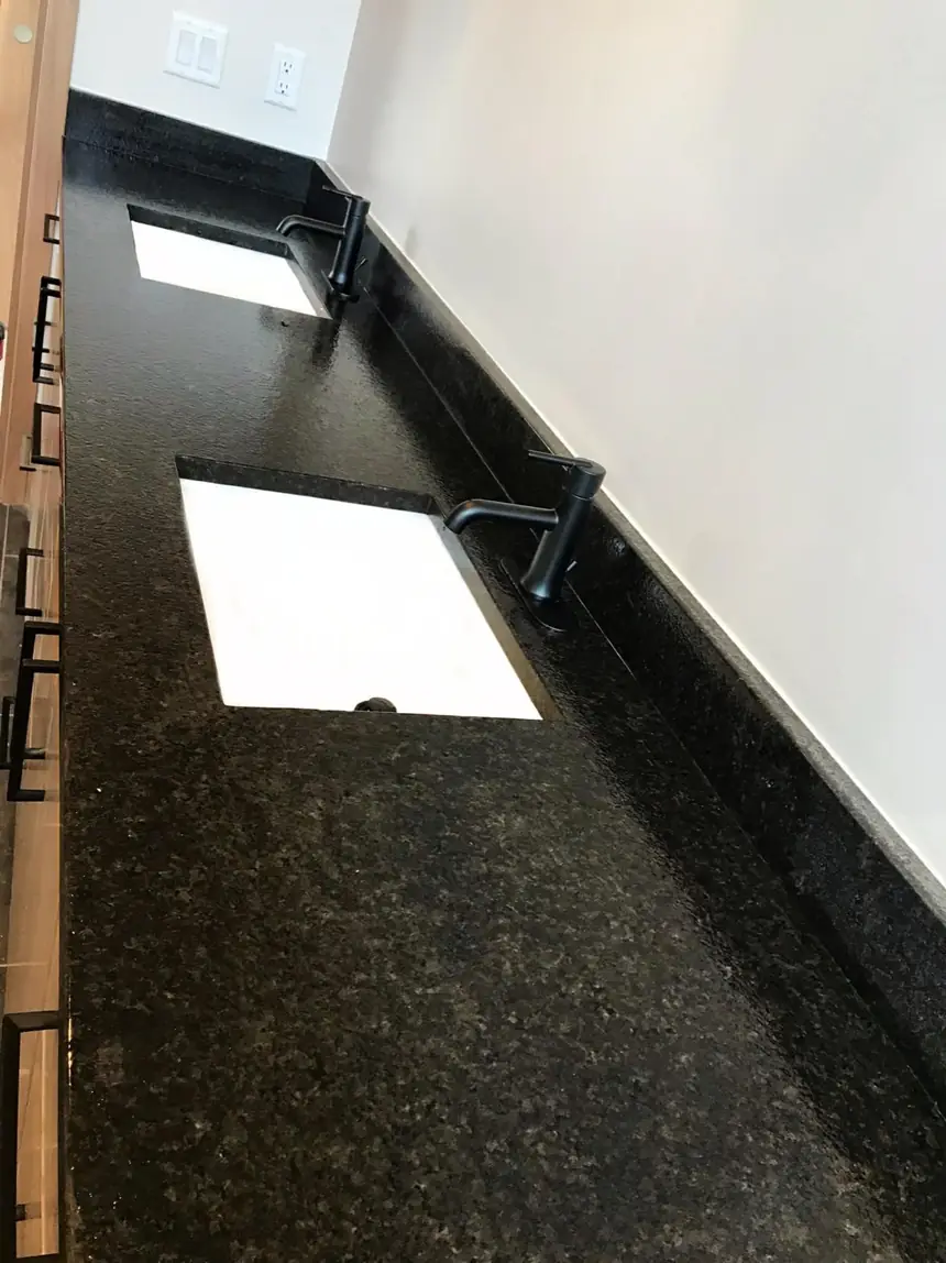After: the same stone vanity and sink after a W.I.P Services final detail clean